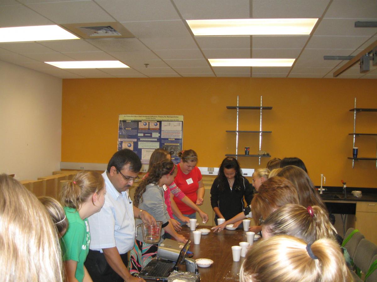 Graduate students (Pamela Roach and Nitin Kolekar) with Prof. Banerjee in the EYH Workshop
